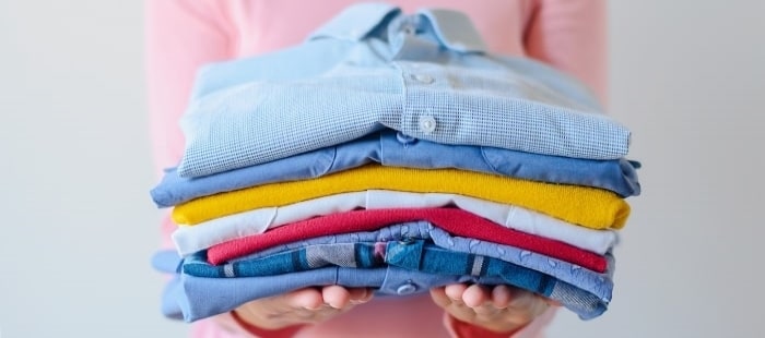 Girl Holding Pile Of Washed And Ironed Clothes Min Min